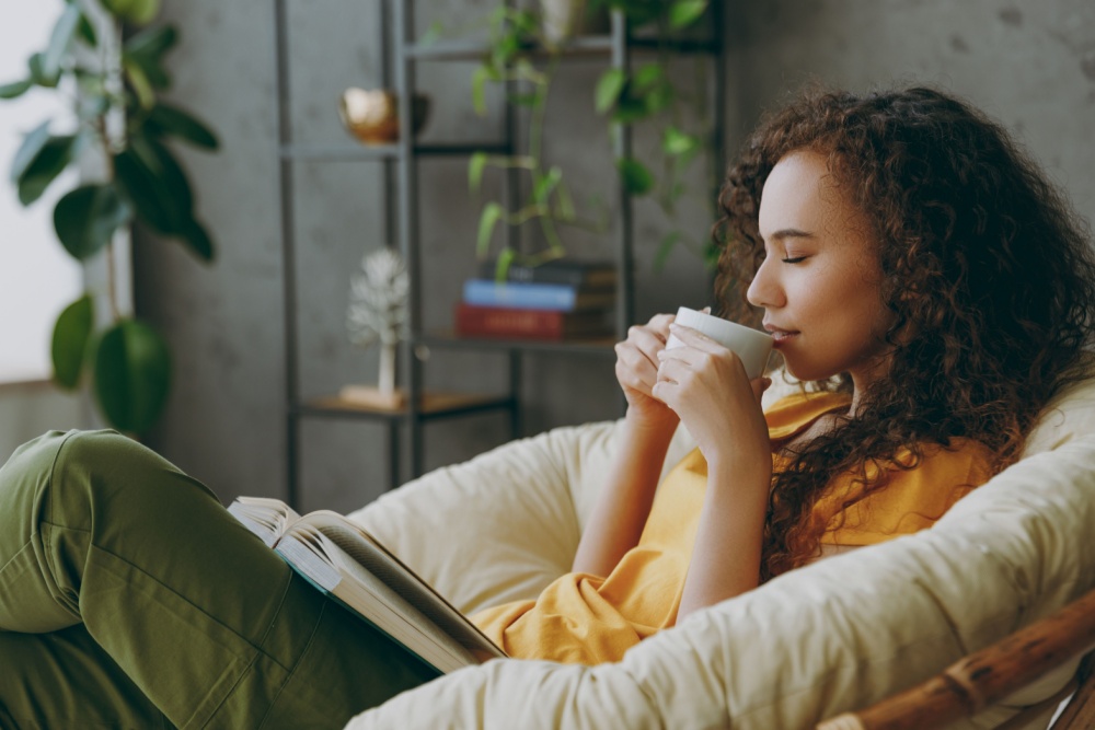 Women sitting relaxing with coffee and a book