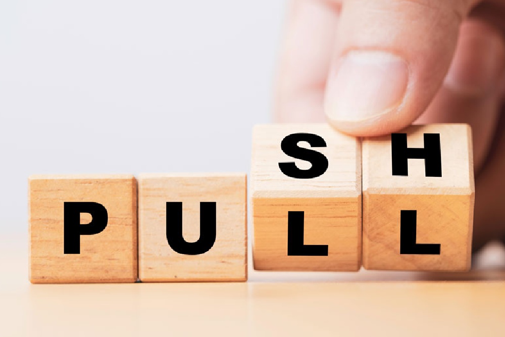Hands turn wooden “push” and “pull” cubes